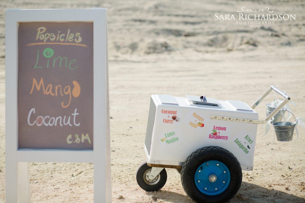 playful additions like this popsicle cart filled this romantic beach wedding