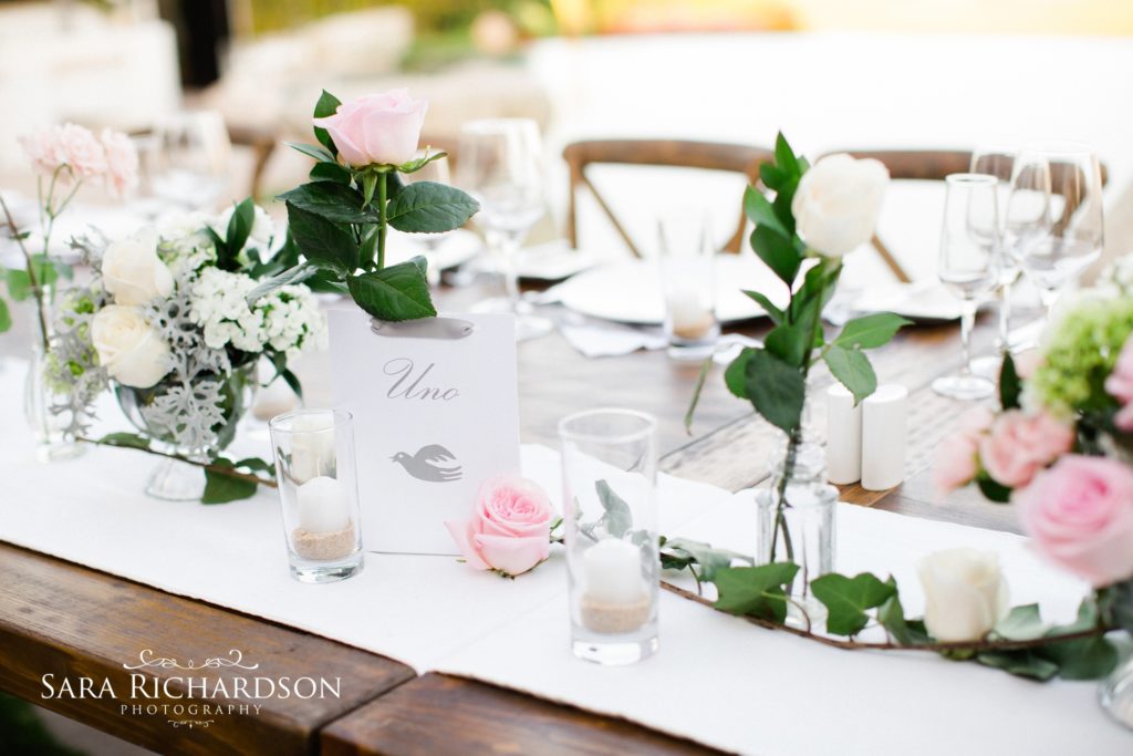 whimsical and classy table settings at a romantic beach wedding