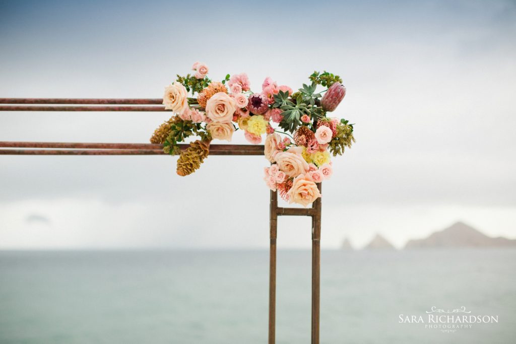 beautiful floral design on the arbor of this modern wedding
