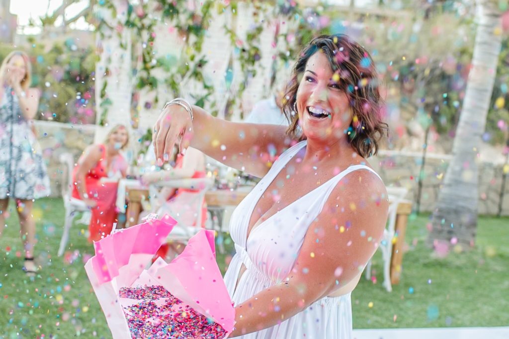 happy bride with confetti during Cabo beach wedding