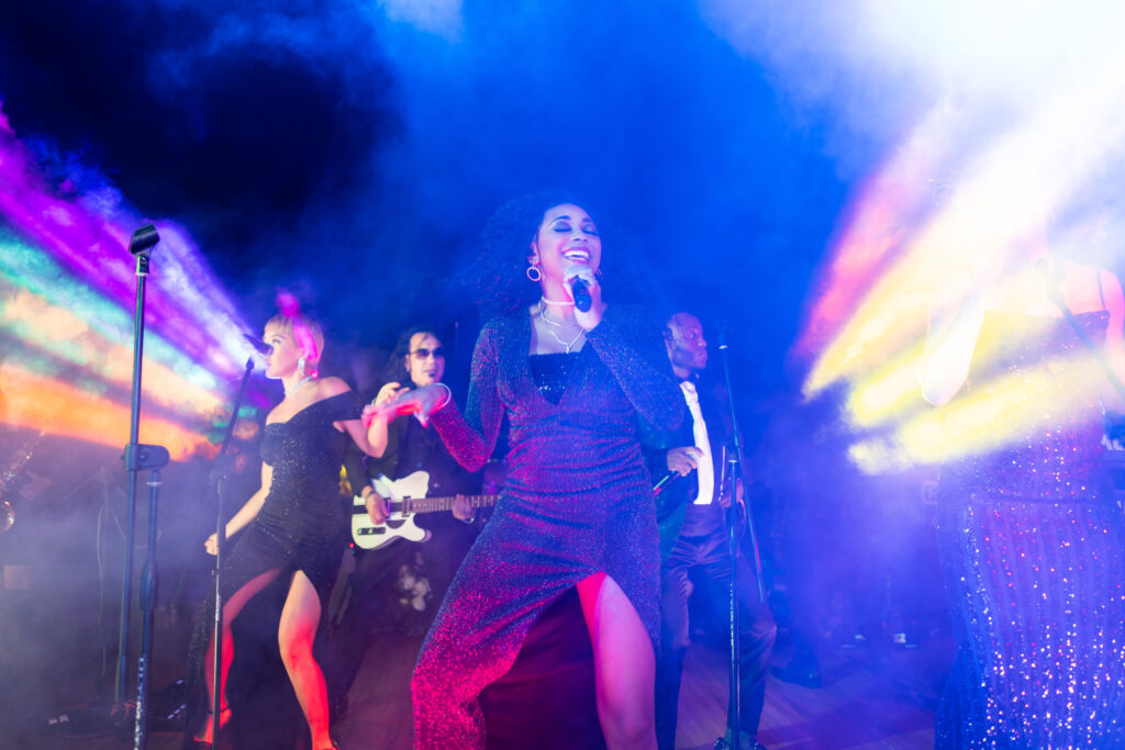 a band playing wedding music at a reception by night