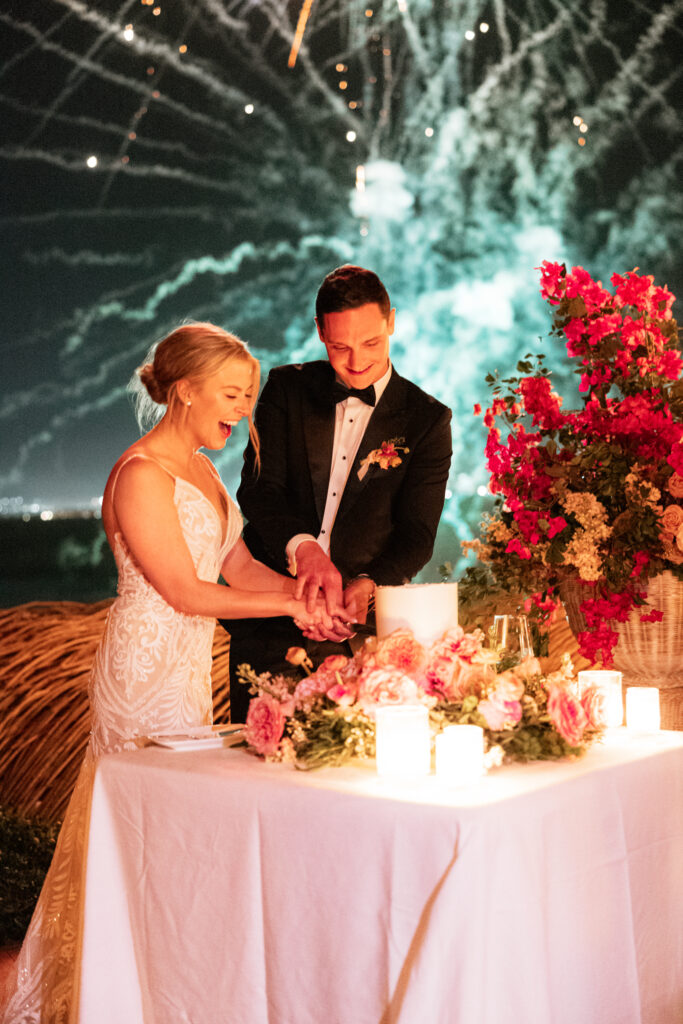 newlyweds cutting their cake during their wedding at Sunset Monalisa